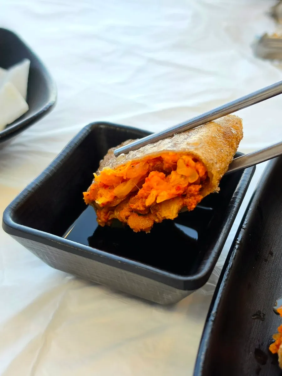 Cross-section of the buckwheat pancake showing the kimchi filling