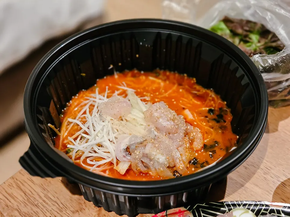 A piece of red sea bream yubiki lifted with chopsticks