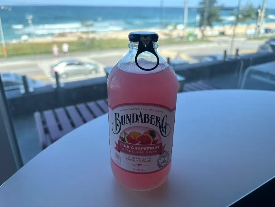 Bread and drinks set against the ocean backdrop