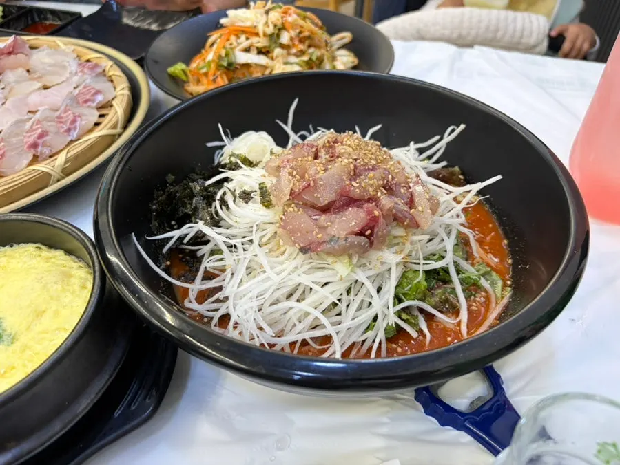 Wrap greens and white kimchi among the side dishes