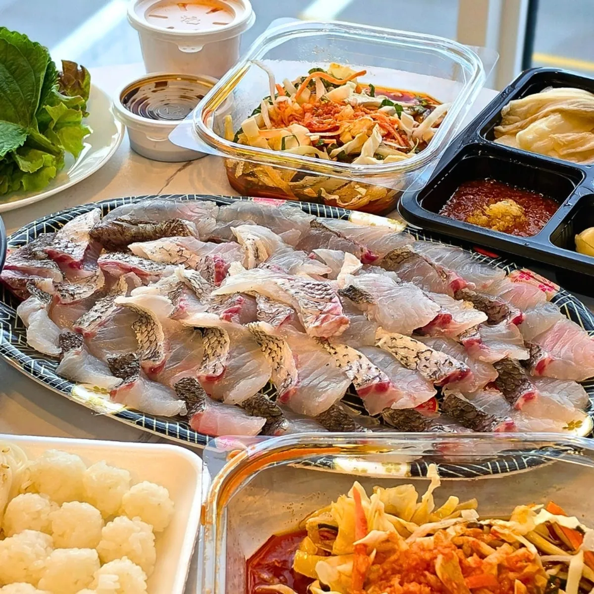 Takeout table spread of red sea bream yubiki sashimi from Samsami-ne at Gyeongpodae, Gangneung