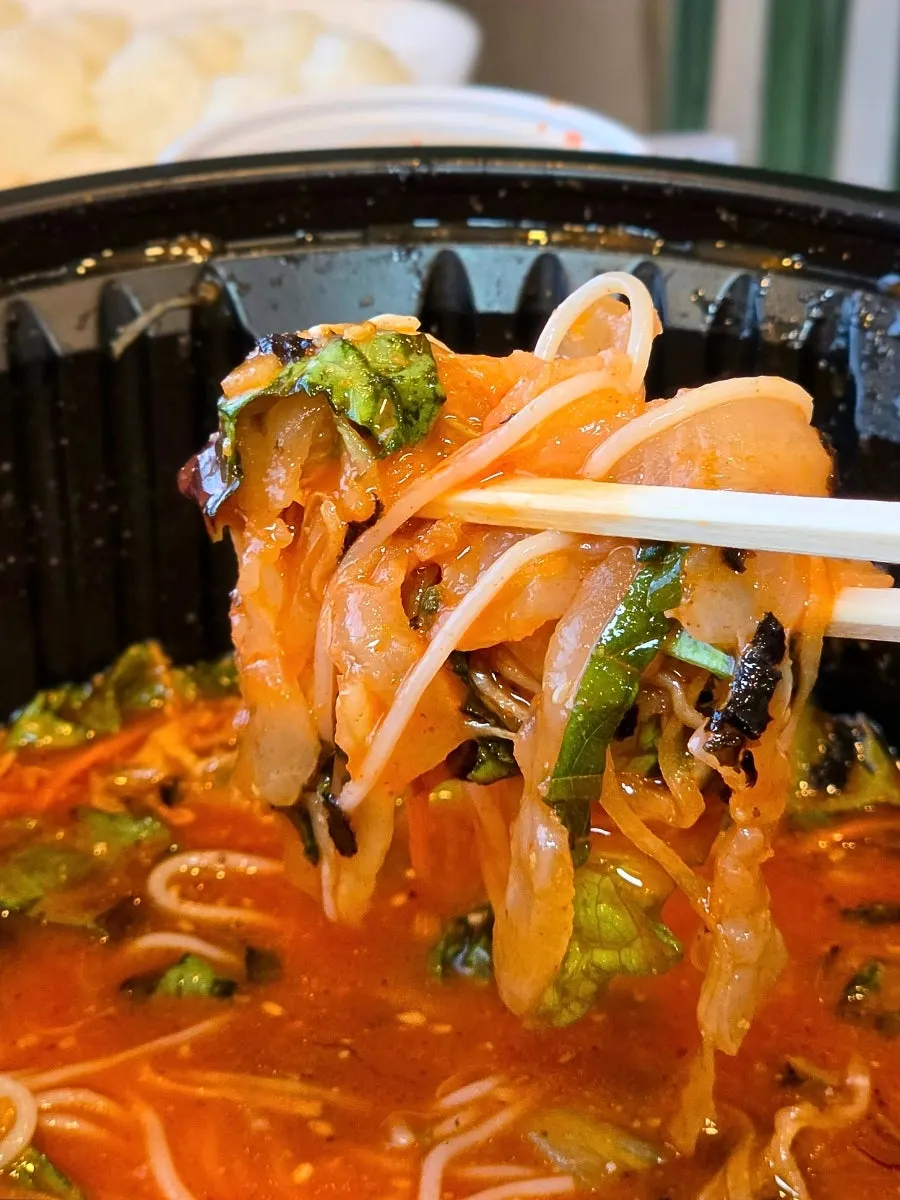 A bowl of mulhoe with a piece of sashimi