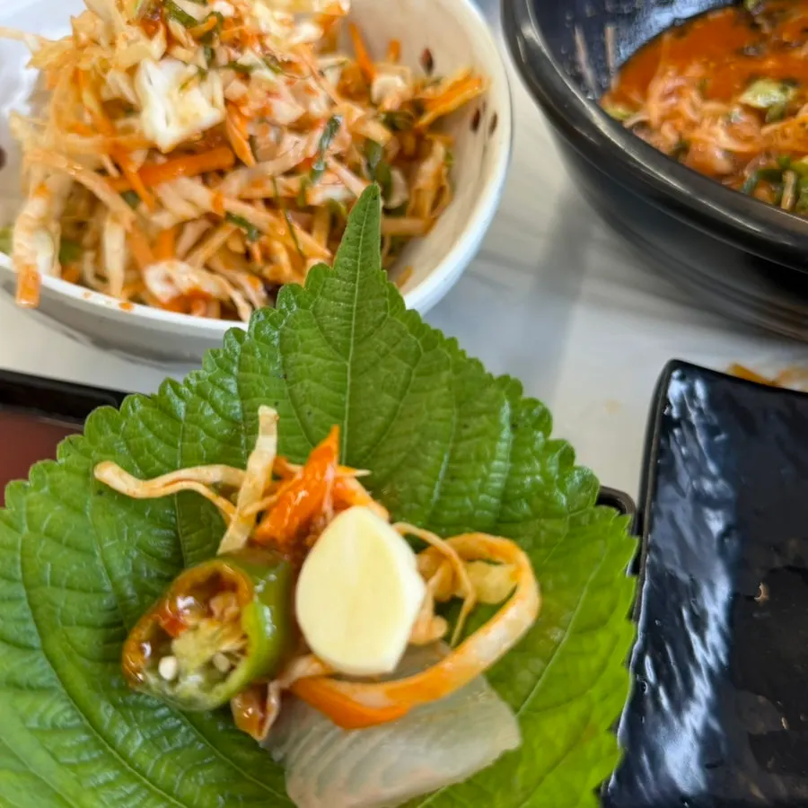 Sashimi and seasoned vegetables wrapped in a perilla leaf