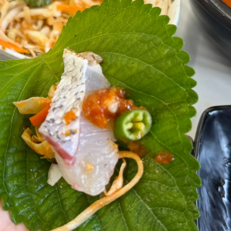 Sashimi topped with wasabi paired with sushi rice