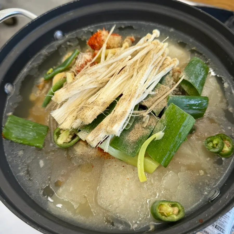 Spicy fish stew boiling on the table