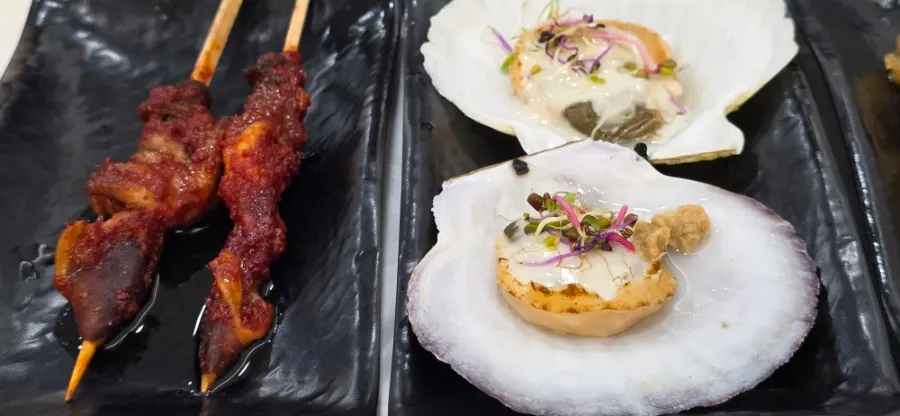 Fried food, steamed egg, and grilled skewers among the side dishes
