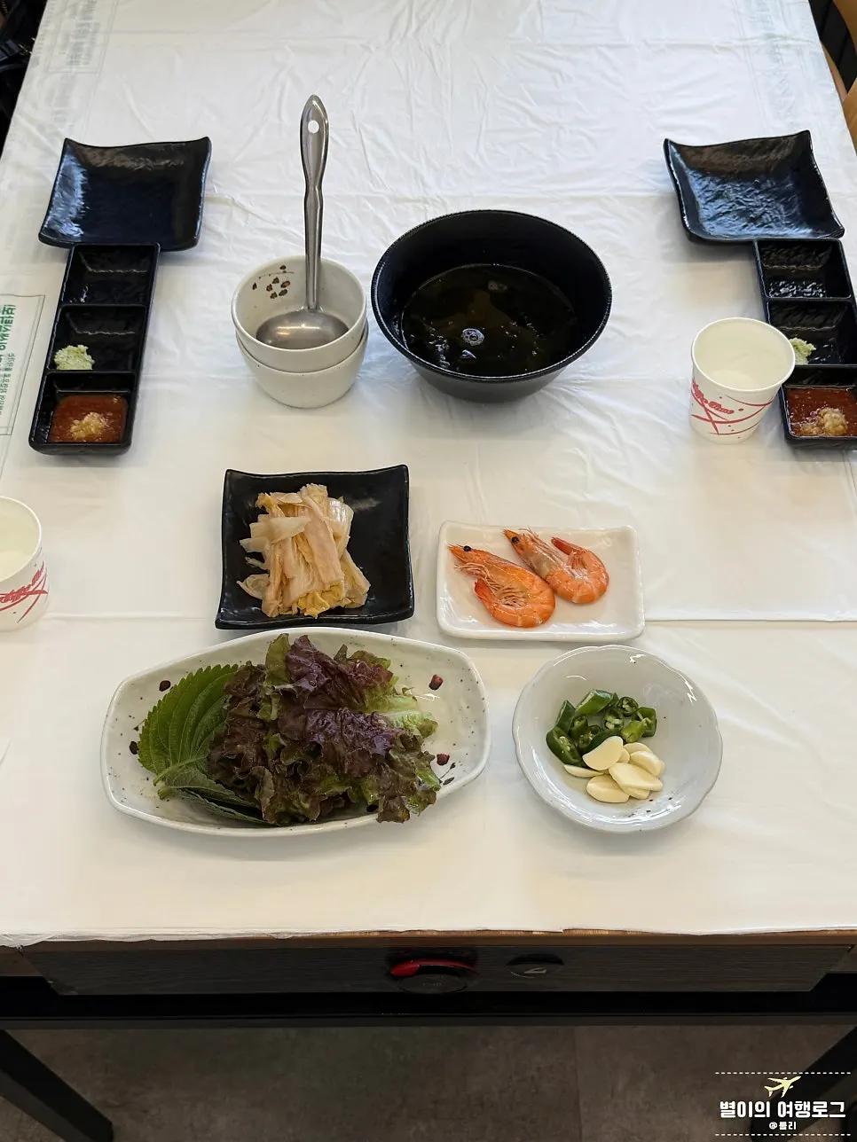 Basic side dish spread with aged kimchi and leafy greens for wraps