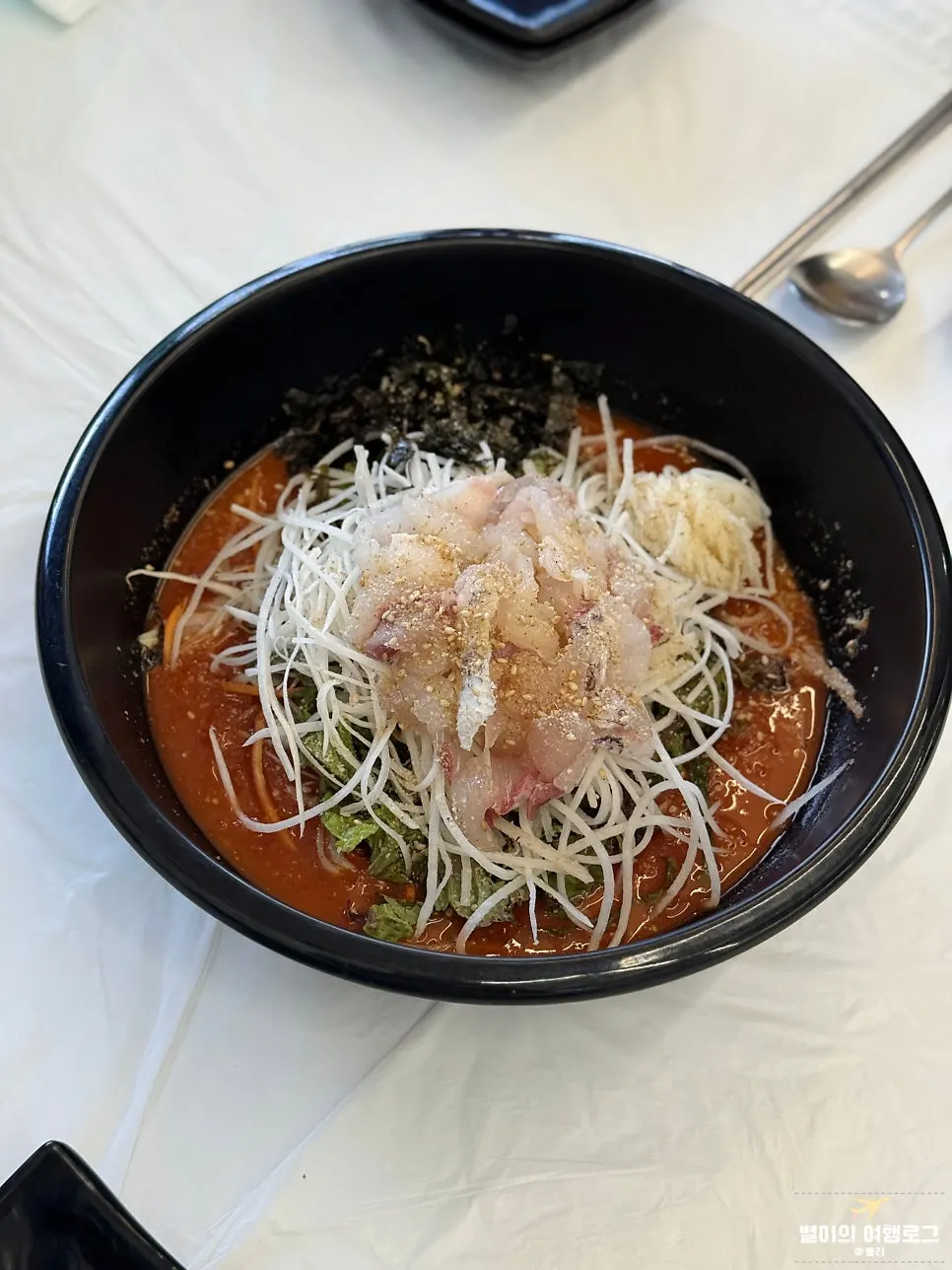 Close-up of mulhoe packed with vegetables and sashimi