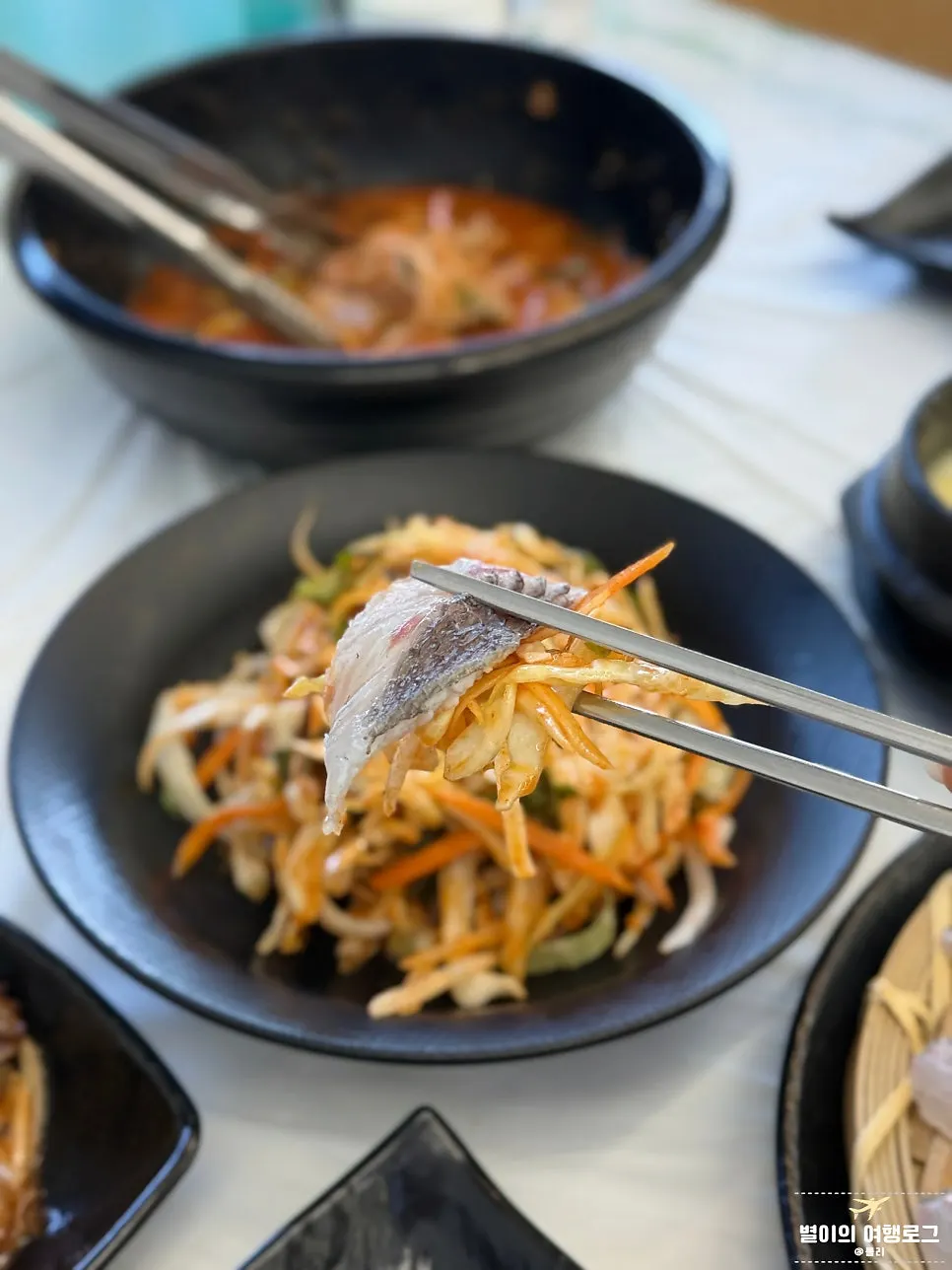 Seasoned raw vegetables served alongside the sashimi