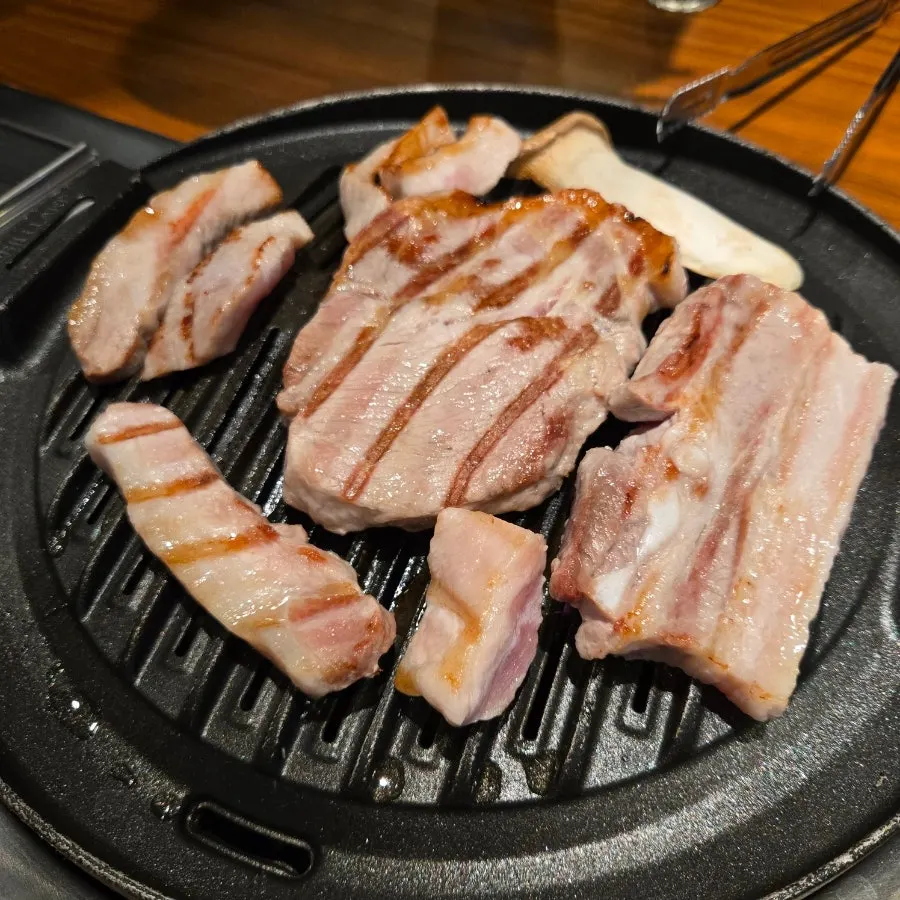 Half-pig platter meat on the grill