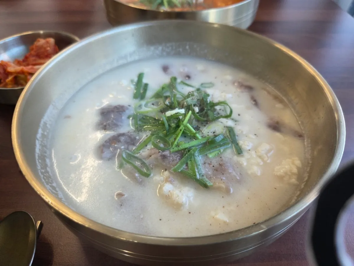 A bowl of beef-bone sundubu filled with pale broth