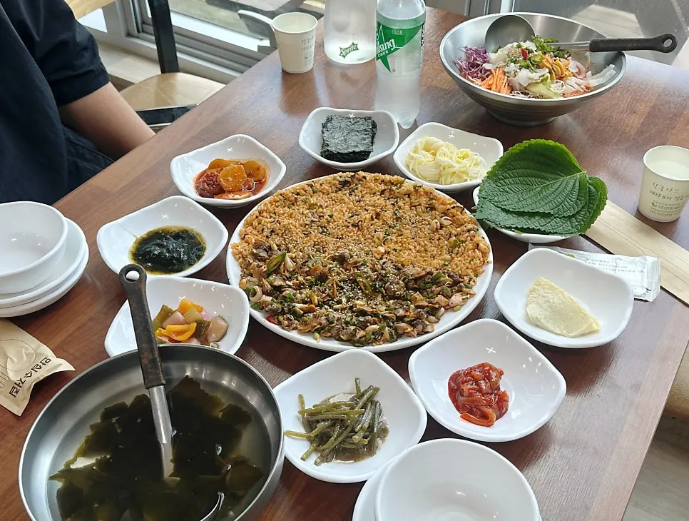 The 2-person set spread, with cockle bibimbap, mulhoe, and side dishes