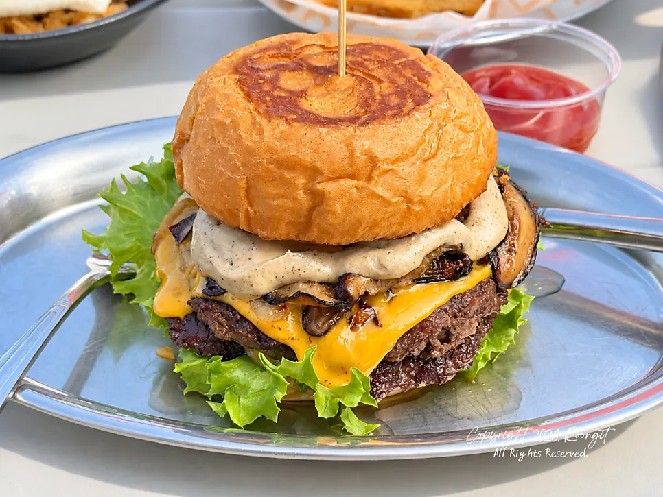 Two burgers set on the table at Burger Bar