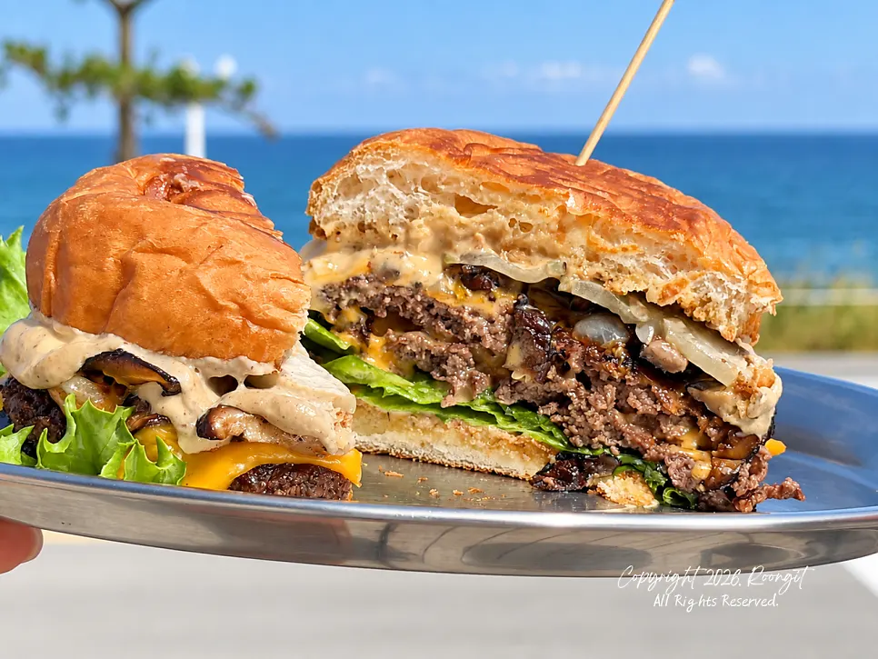 Cross-section of the burger showing the thick patty and songgo mushroom