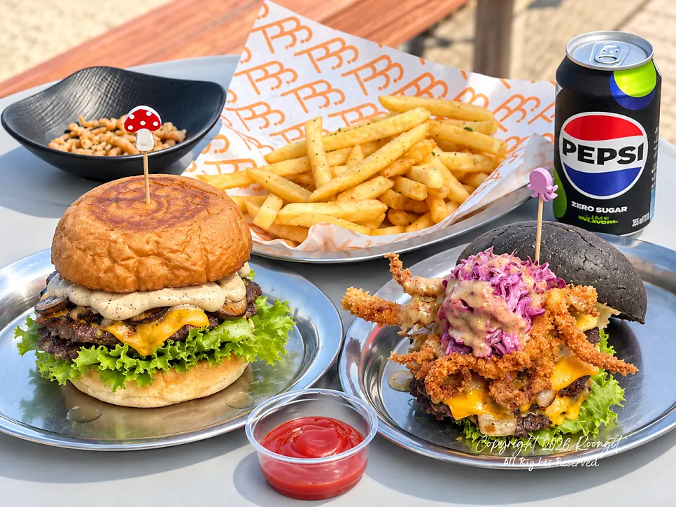 A bite of the songgo mushroom burger with white wine mushroom sauce