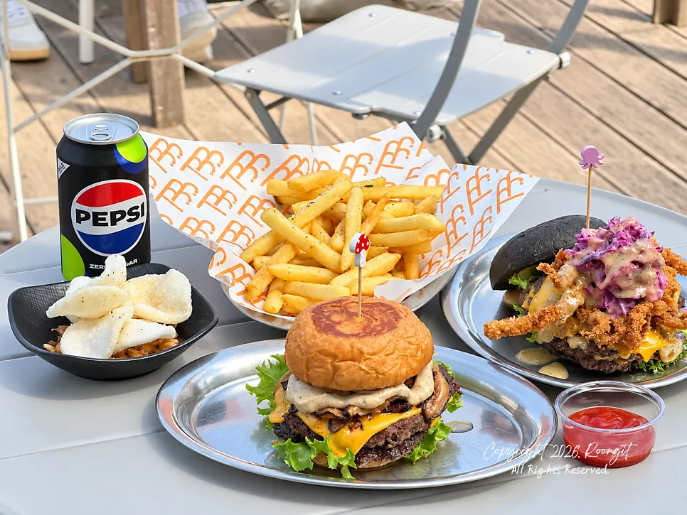 Burger spread set out on an ocean-view terrace table