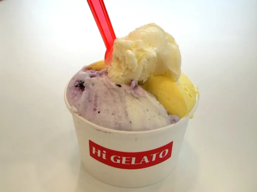 Scooping gelato from a large cup