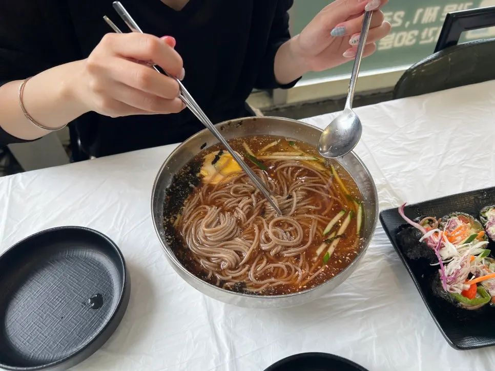 Noodles lifted from the pine nut sundubu broth
