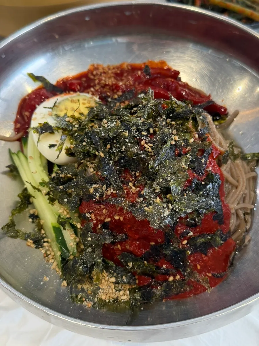 A spread of makguksu served with sundubu