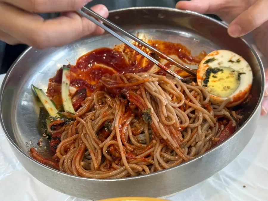 Bibim makguksu with buckwheat noodles and pollock sikhae