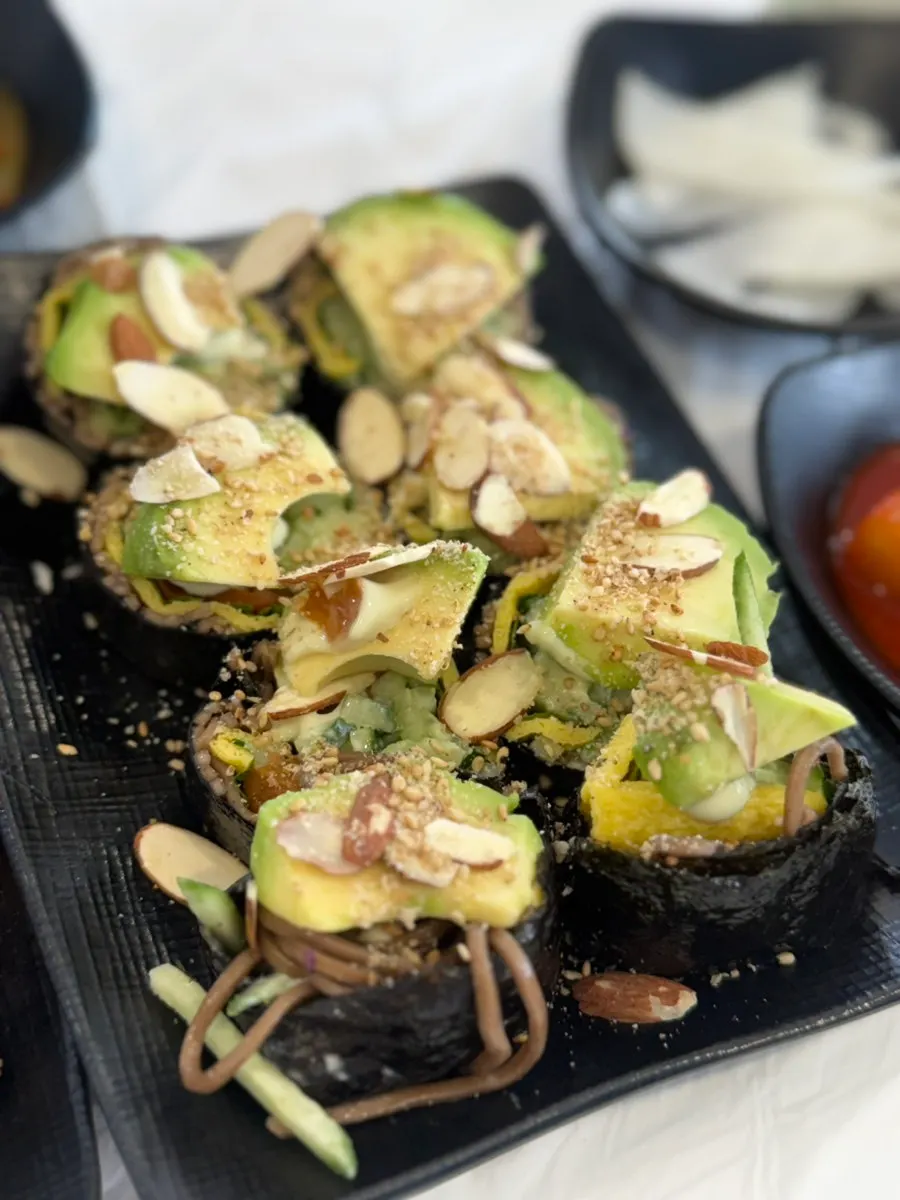 Buckwheat gimbap topped with avocado and sliced almonds