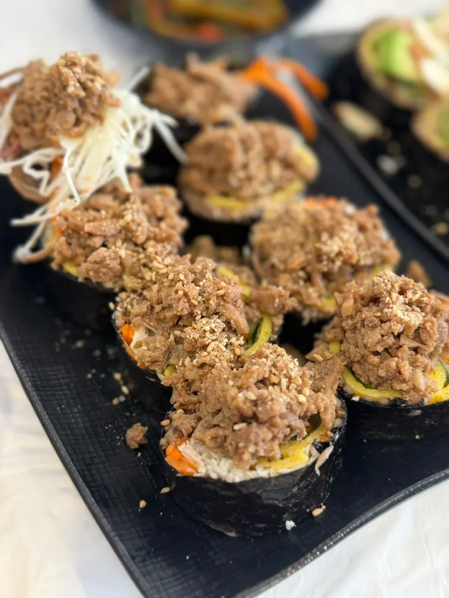 Buckwheat gimbap generously topped with soy-sauce pork