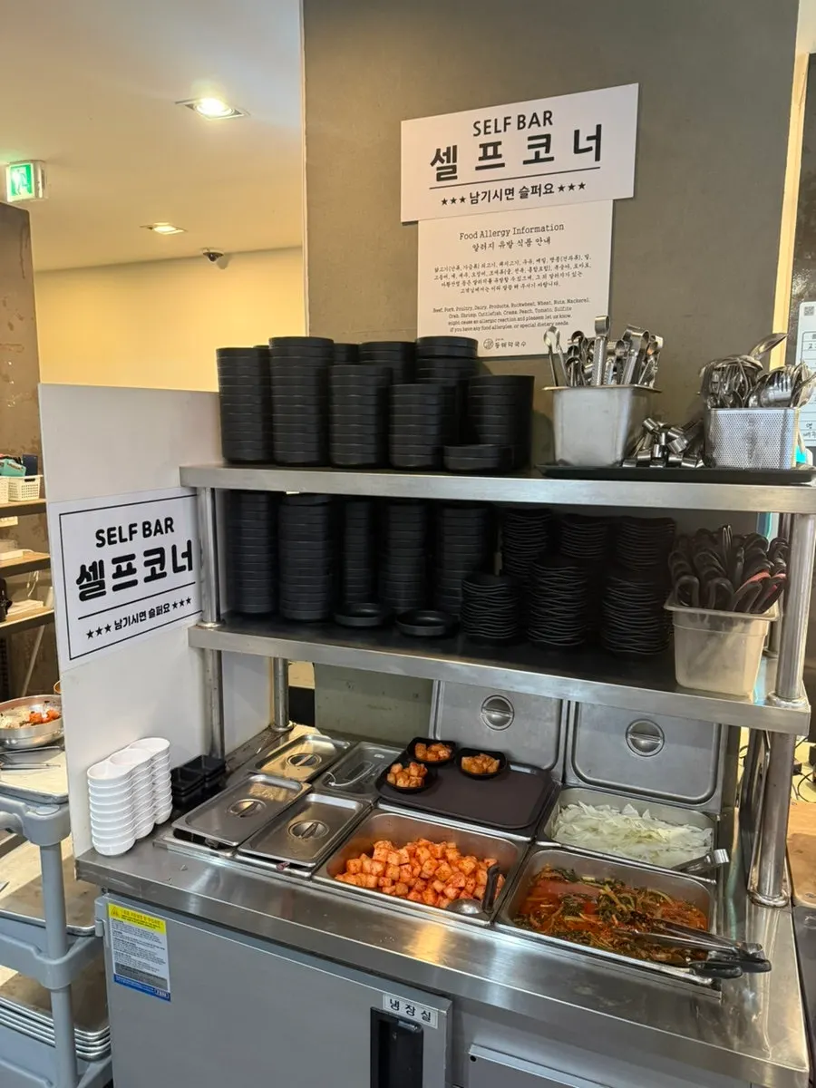 Makguksu and sundubu menu posted on the wall