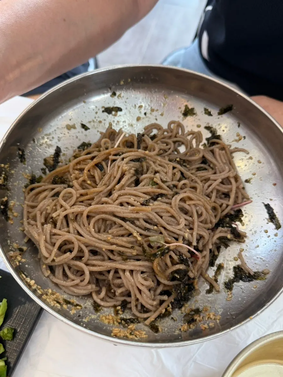 Perilla oil makguksu noodles mixed until glossy