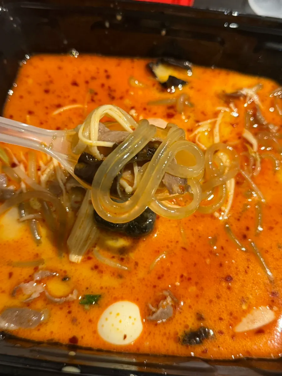 Glass noodles and enoki mushrooms soaked in broth