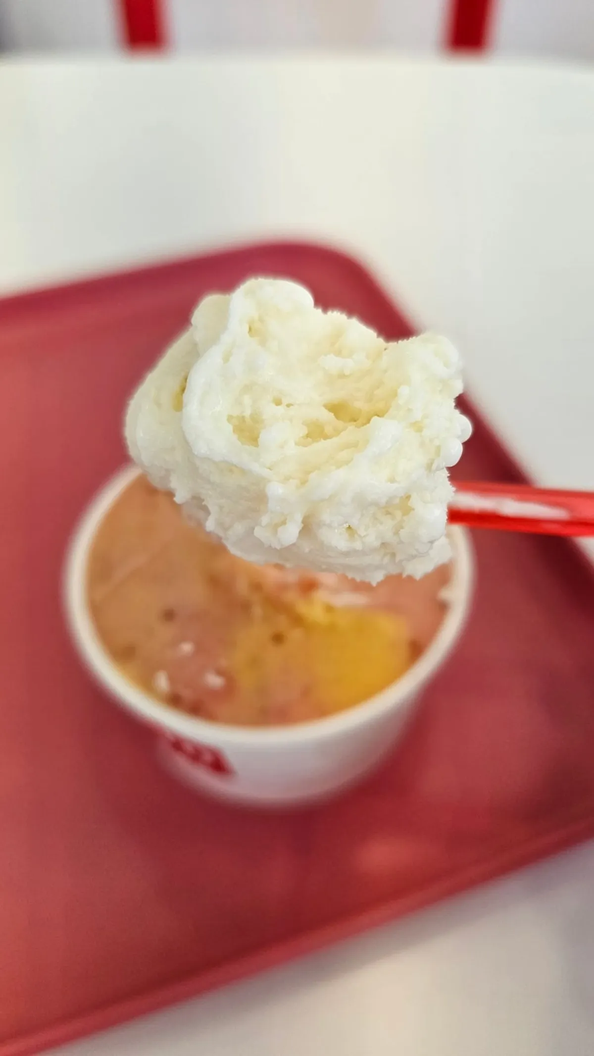Soft tofu gelato served on a tasting spoon