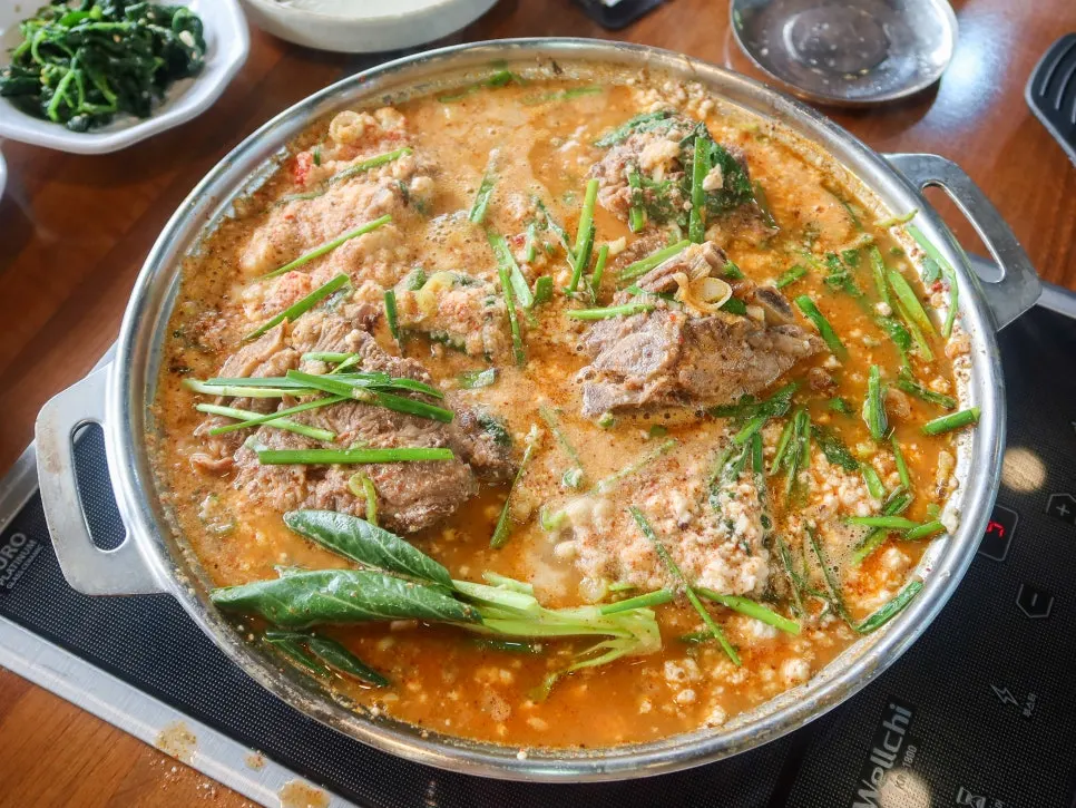 Pot showing rich meat broth mixed with snow-white sundubu