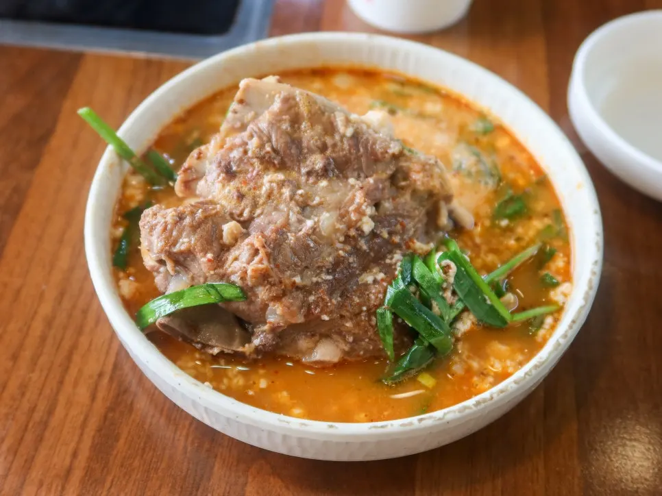 A ladle lifting up the sundubu gamjatang broth