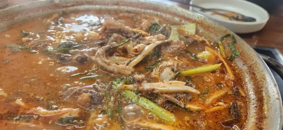 A bite combining beef tripe, honeycomb tripe, and octopus