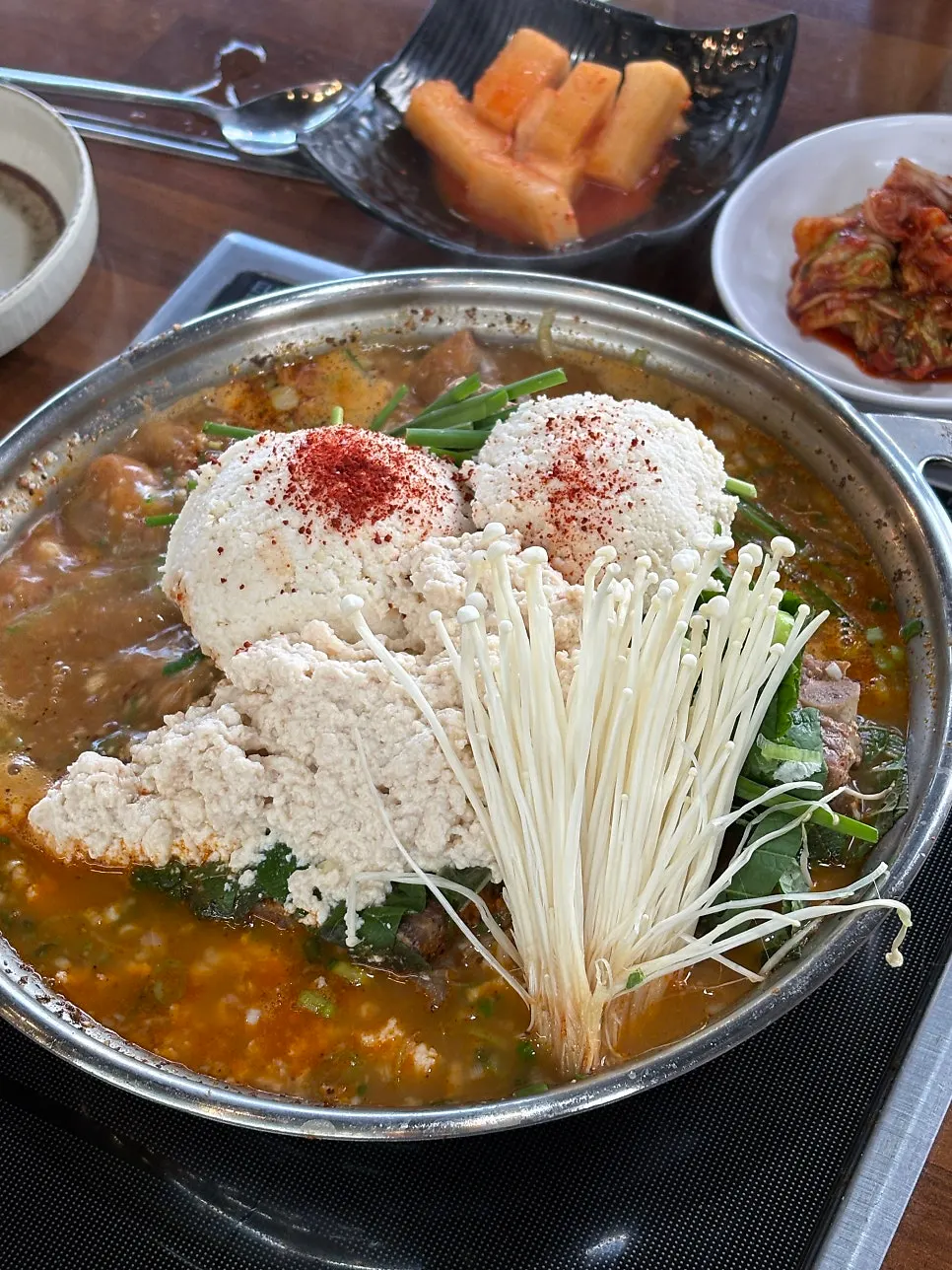 Handmade pork cutlet served with sauce poured over it