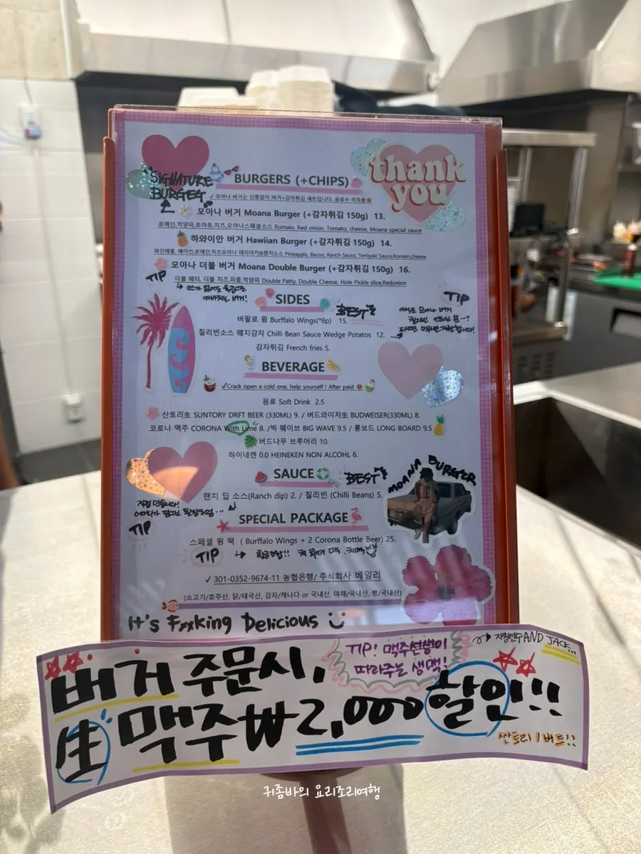 Moana Burger's menu board listing burgers and sides with prices