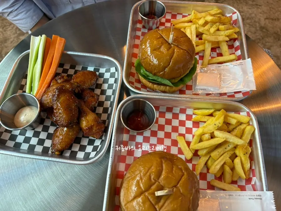 Table set with two burgers and buffalo wings