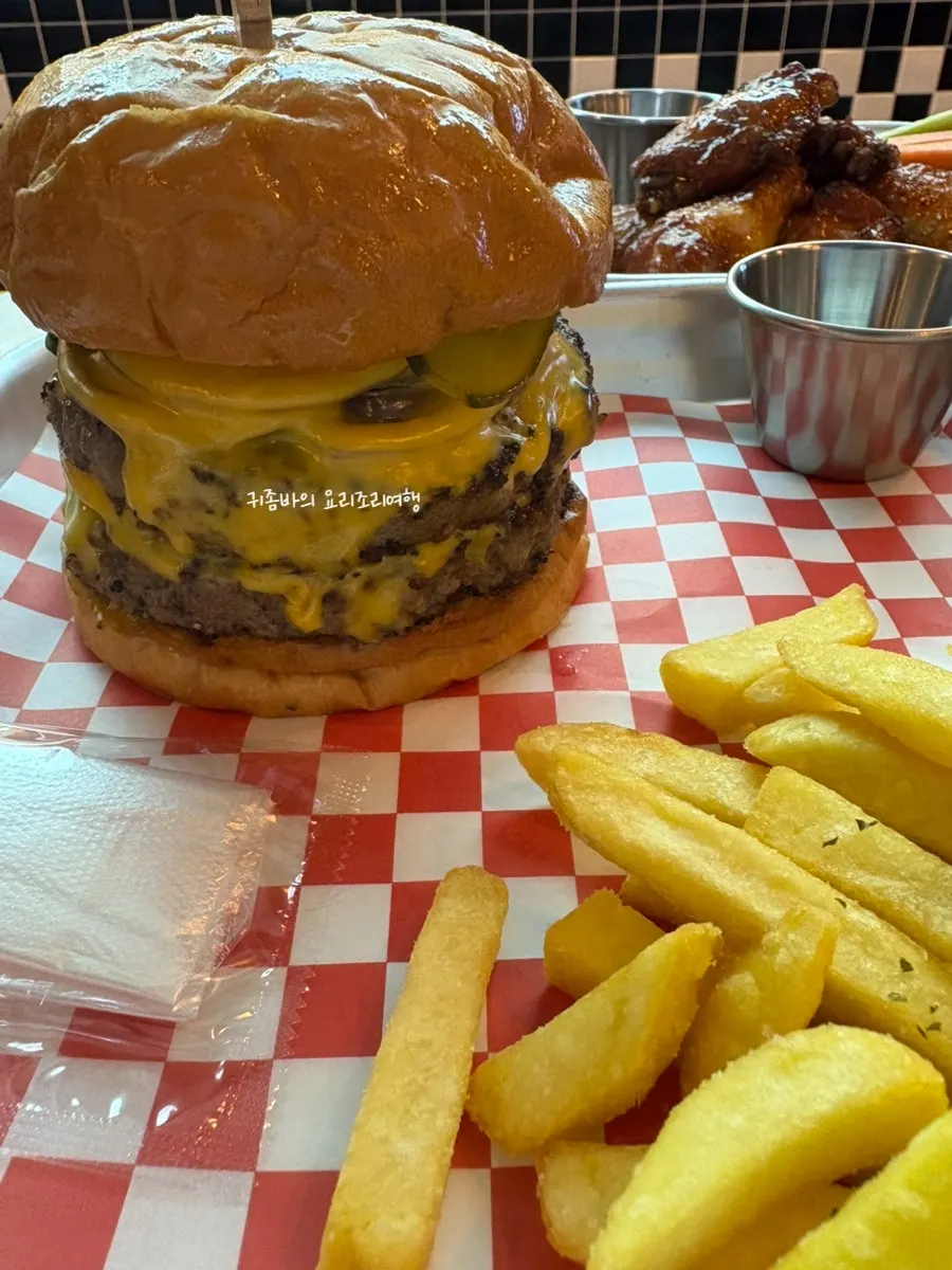 Juices dripping from the double burger when pressed by hand