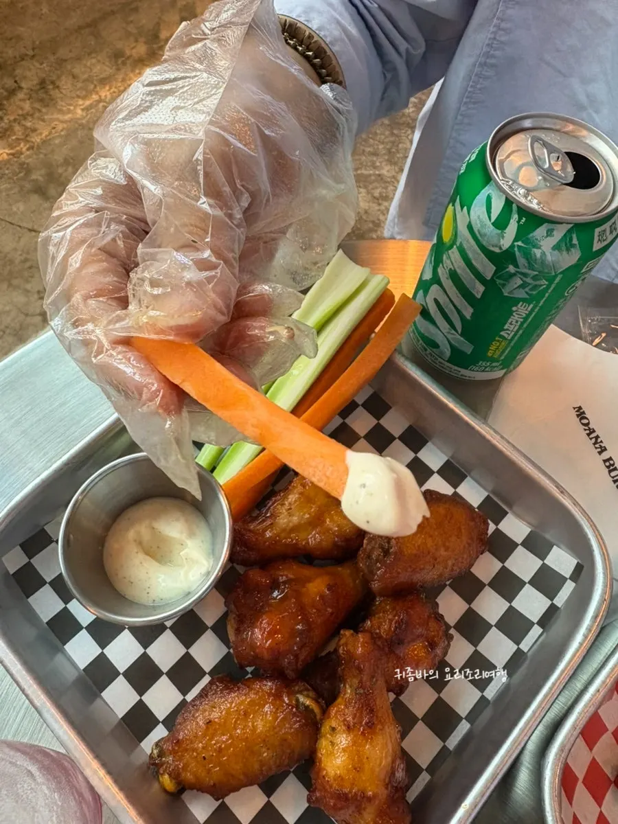 Carrots, celery, and ranch sauce served alongside the buffalo wings