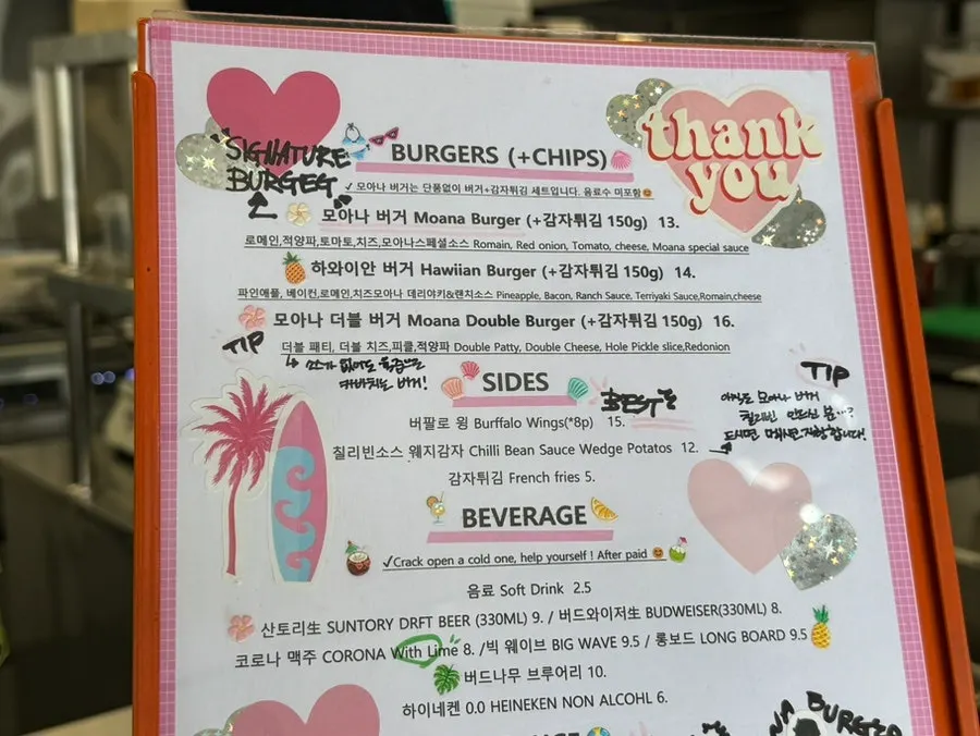 Moana Burger's menu board with burgers and sides
