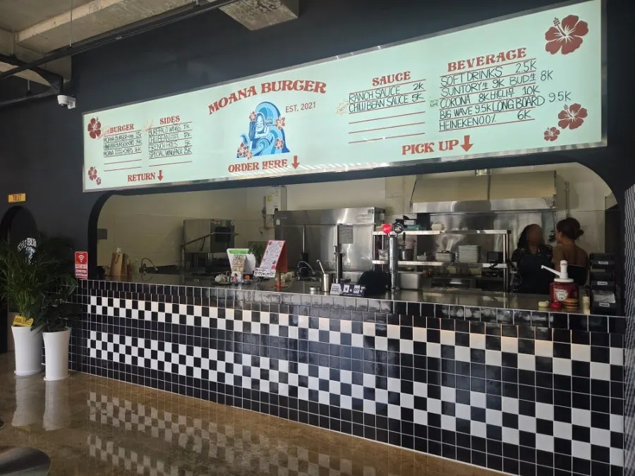 Exterior of the burger shop with black-and-white stripe accents