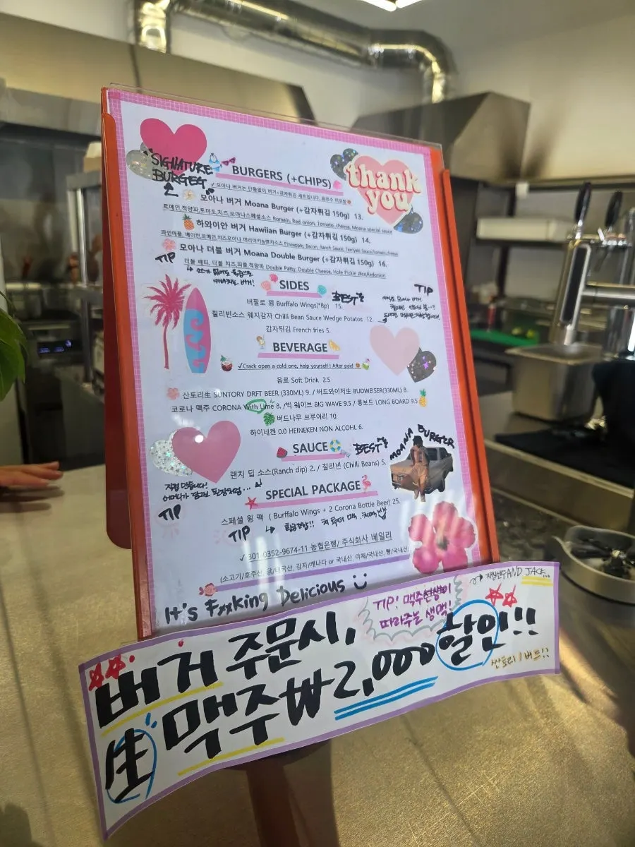 Menu board listing the three handmade burgers