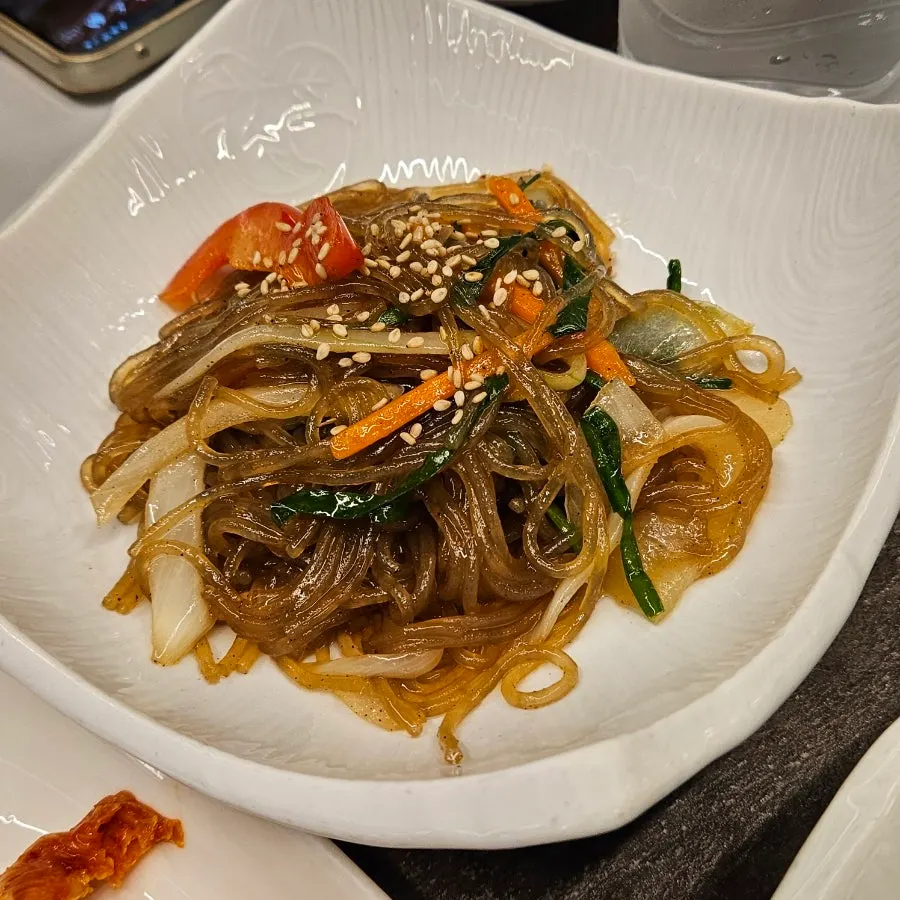 Tidy full spread of side dishes served with woo-dae galbi