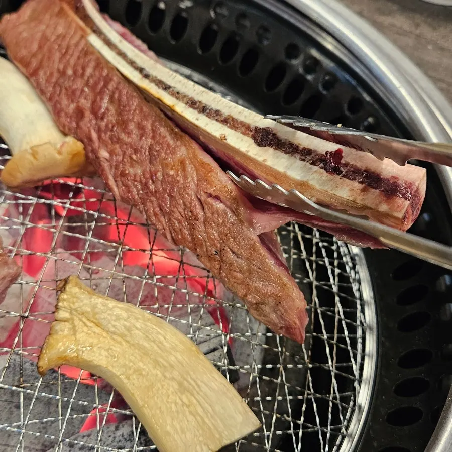 Woo-dae galbi being grilled by hand