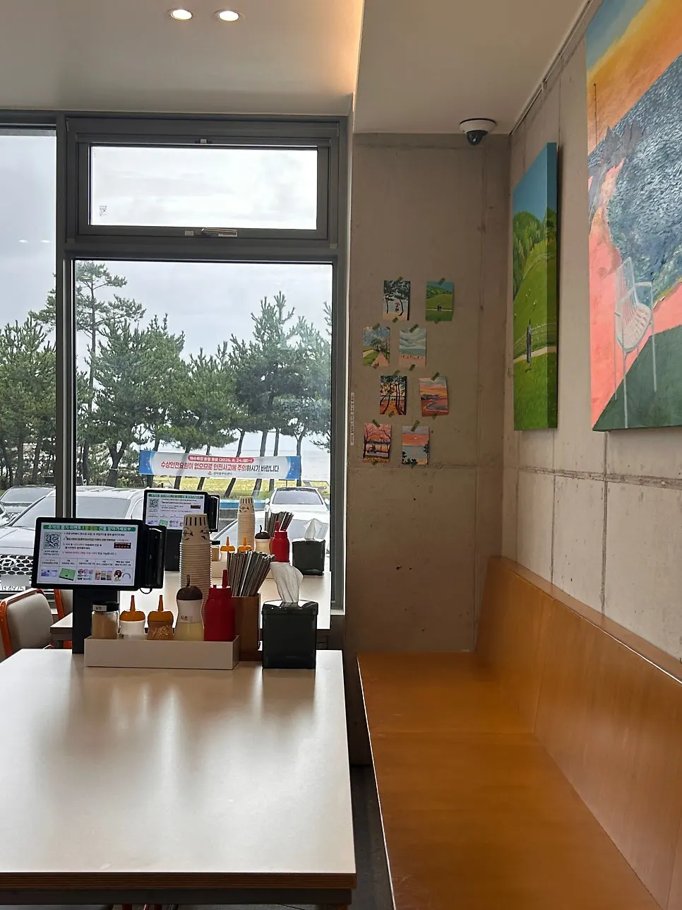Interior of the makguksu restaurant with colorful paintings on the wall