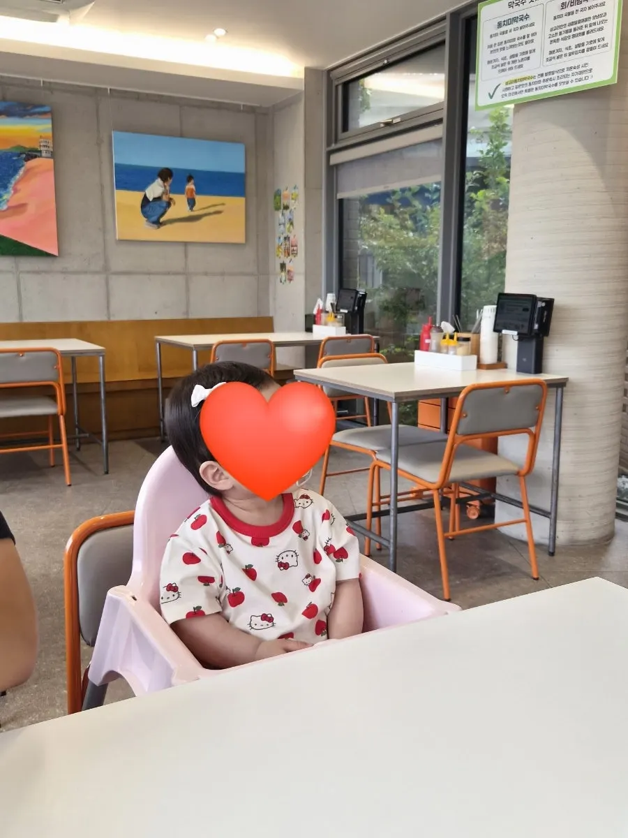 Café-like dining hall interior with paintings on the wall