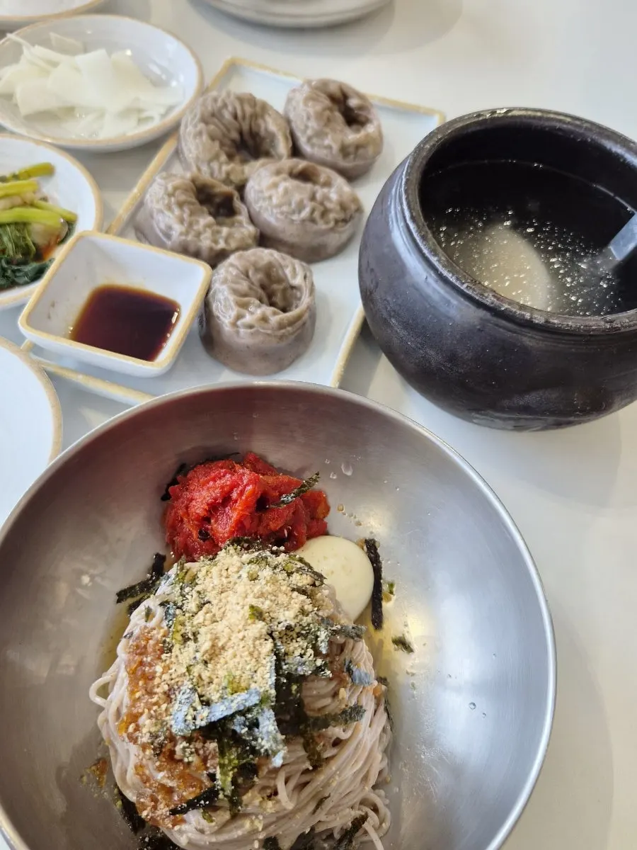 Table setting with a pitcher of dongchimi served as standard