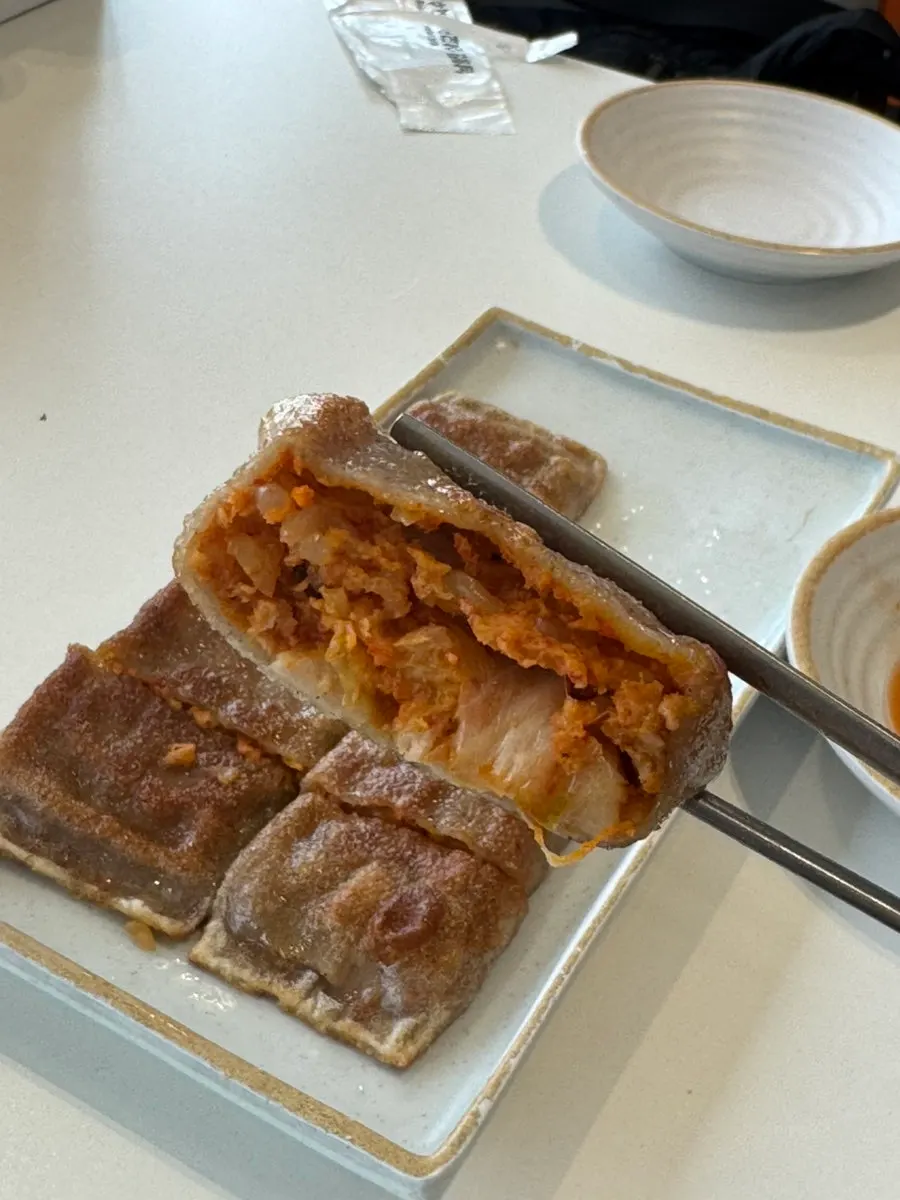Cross-section of buckwheat pancake showing spicy kimchi filling
