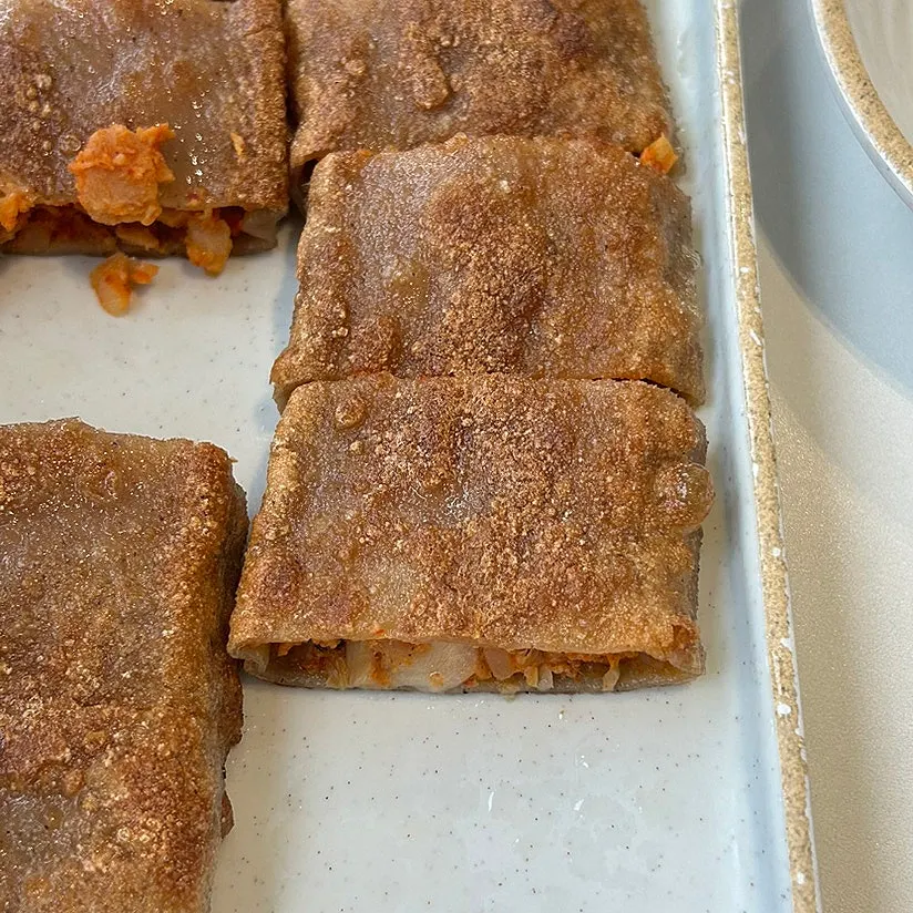 Cross-section of the buckwheat pancake showing kimchi filling