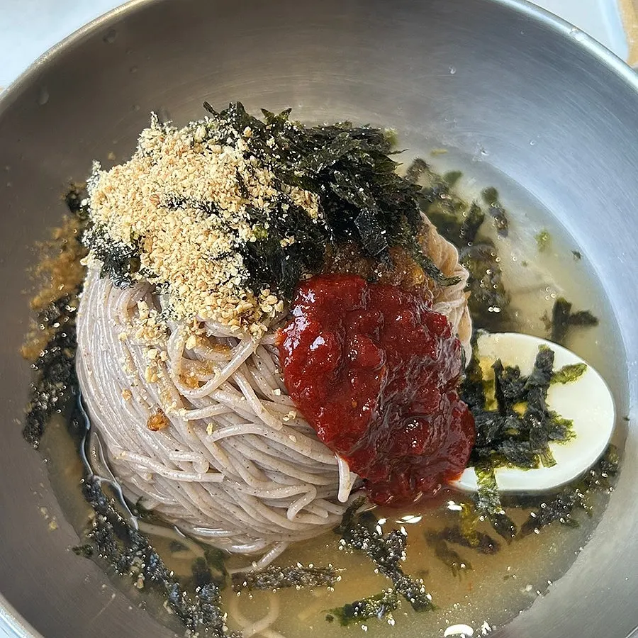 Bowl of makguksu with sauce added