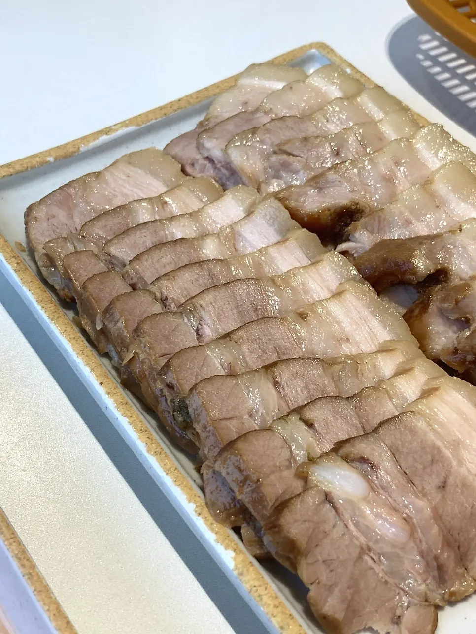 A piece of sujuk wrapped in baek-kimchi